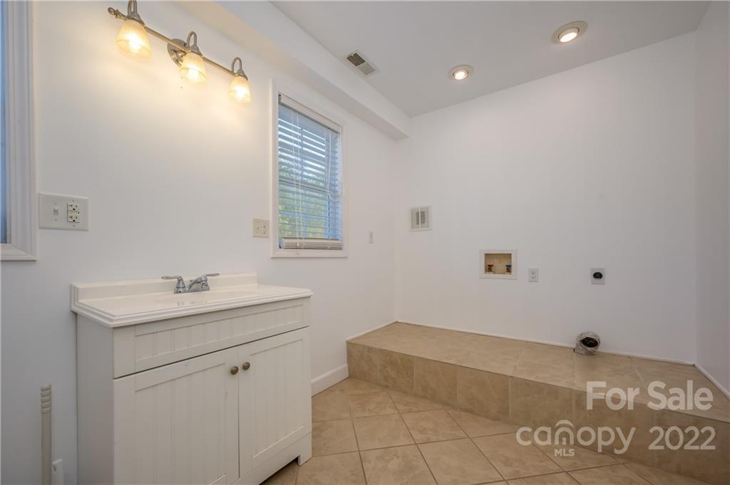 1591 Jack McKinney Road Rutherfordton, NC 28139 - Photo 23 of 34 a bathroom with a sink and a bathtub