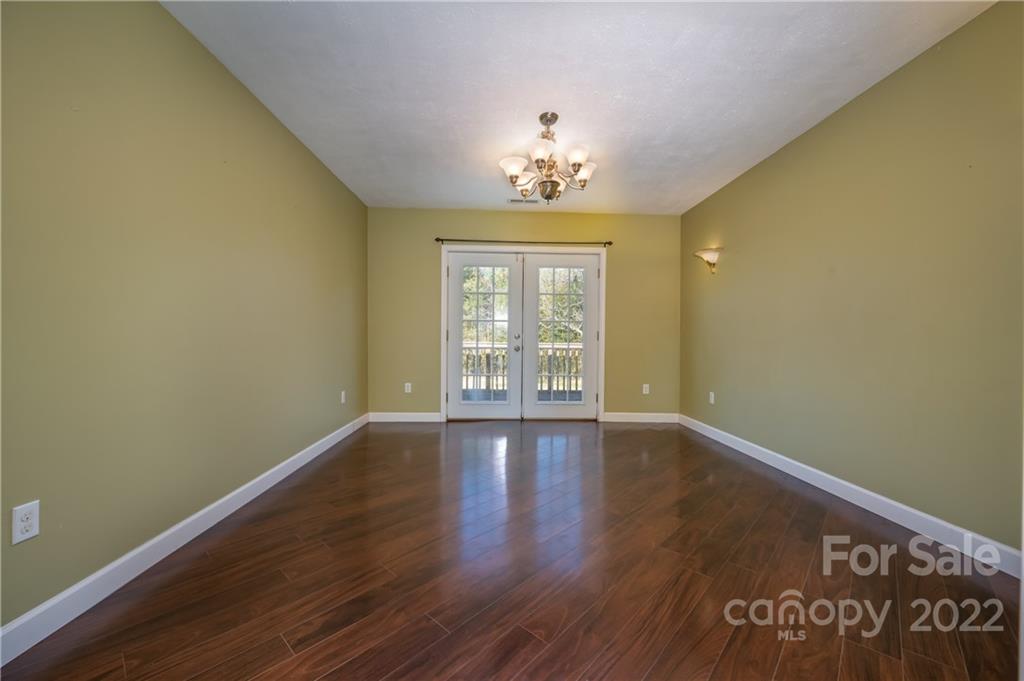 1591 Jack McKinney Road Rutherfordton, NC 28139 - Photo 8 of 34 a view of an empty room with wooden floor and a window