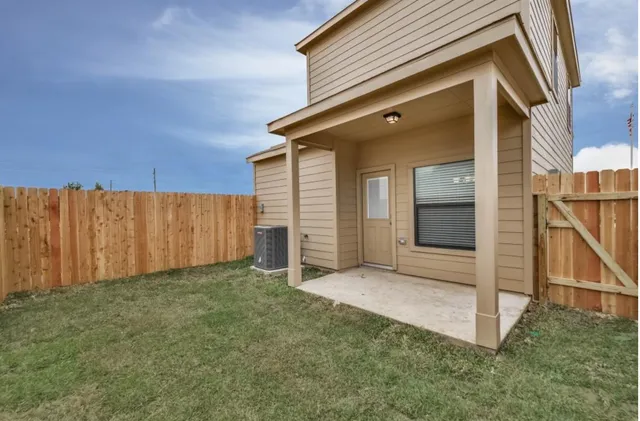 a view of a backyard with wooden fence
