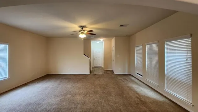 a kitchen with refrigerator and cabinets