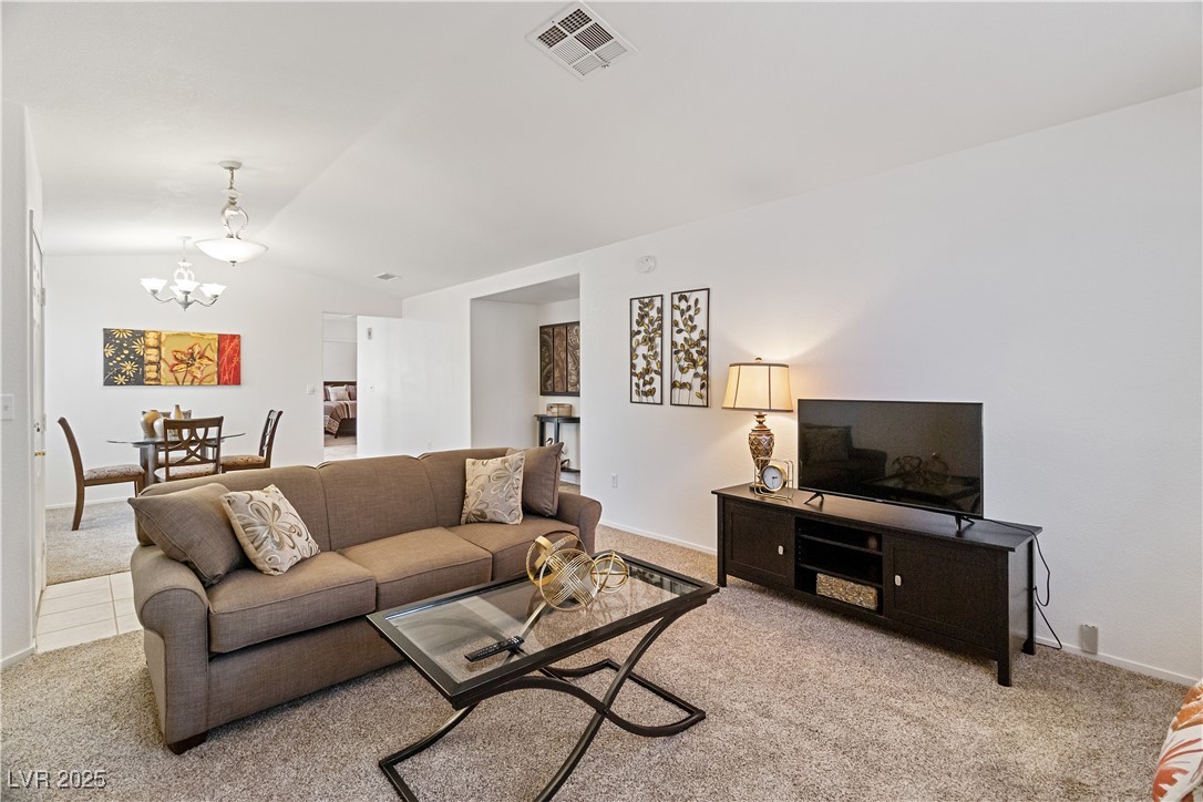 2297 Camel Mesa Drive Laughlin, NV 89029 - Photo 14 of 98 Carpeted living area with vaulted ceiling and a chandelier