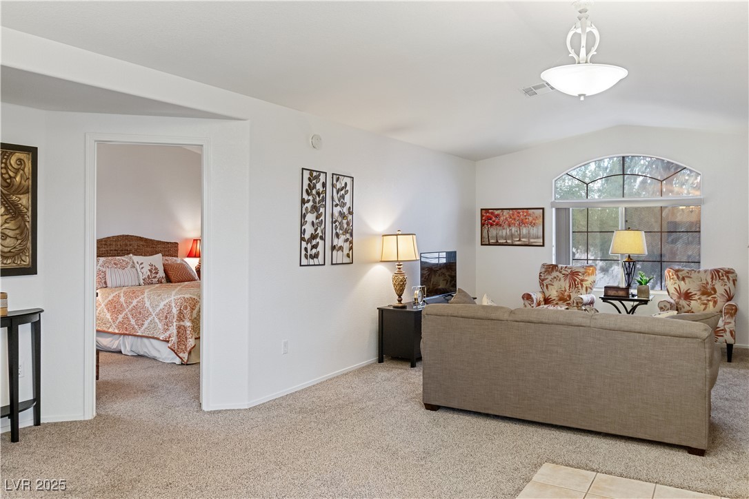 2297 Camel Mesa Drive Laughlin, NV 89029 - Photo 19 of 98 Carpeted living area with baseboards and lofted ceiling
