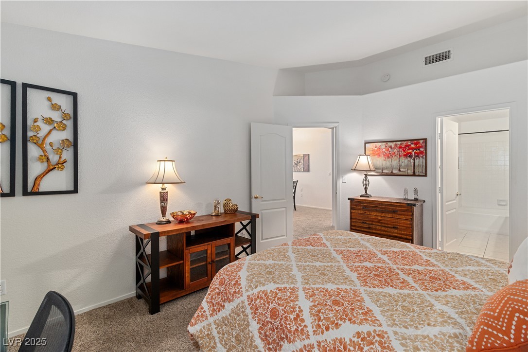 2297 Camel Mesa Drive Laughlin, NV 89029 - Photo 23 of 98 Primary bedroom with light colored carpet and ensuite bath