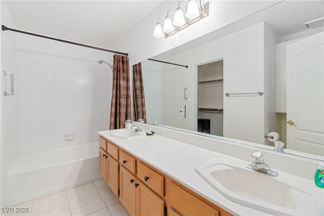 2297 Camel Mesa Drive Laughlin, NV 89029 - Photo 24 of 98 Primary Bathroom with shower / bath combo with shower curtain, double vanity, and light tile patterned floors