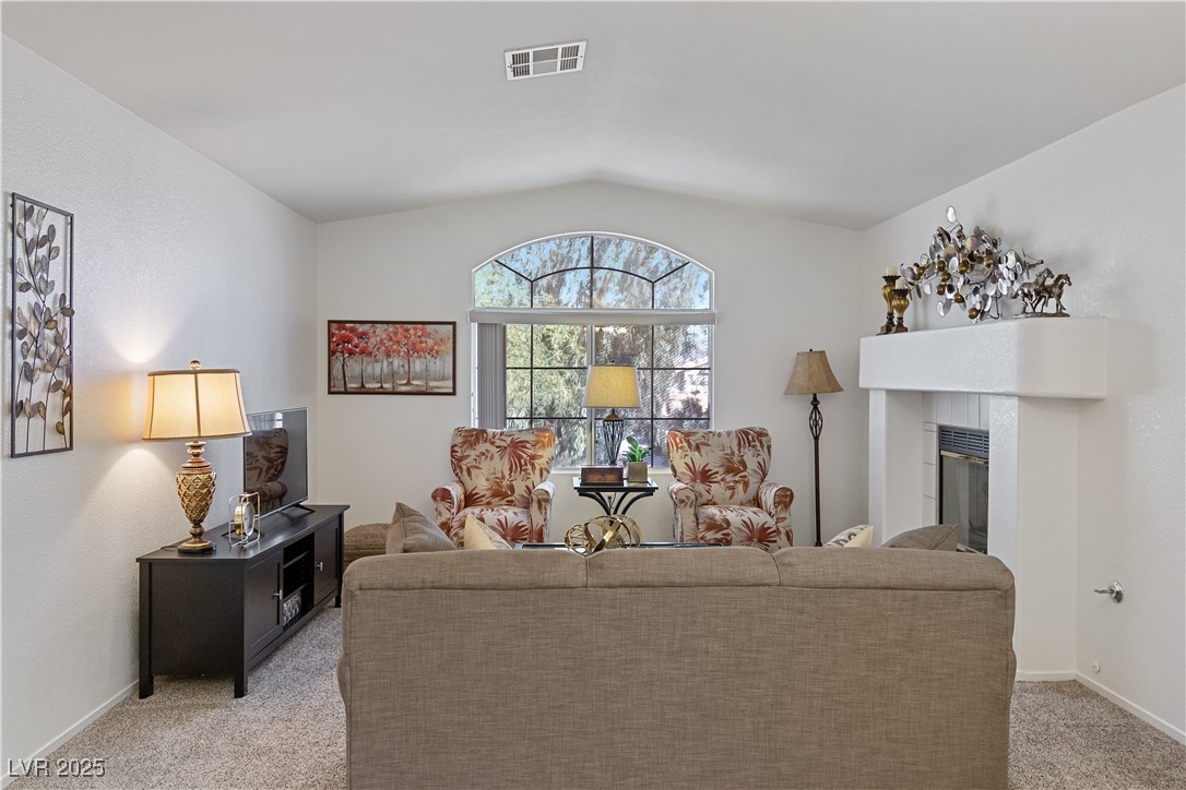 2297 Camel Mesa Drive Laughlin, NV 89029 - Photo 7 of 98 Carpeted living room with a tile fireplace and vaulted ceiling