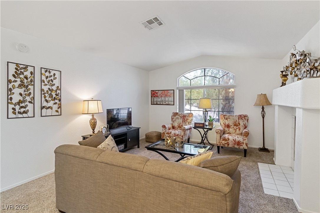 2297 Camel Mesa Drive Laughlin, NV 89029 - Photo 8 of 98 Living area featuring light carpet, vaulted ceiling, and a fireplace