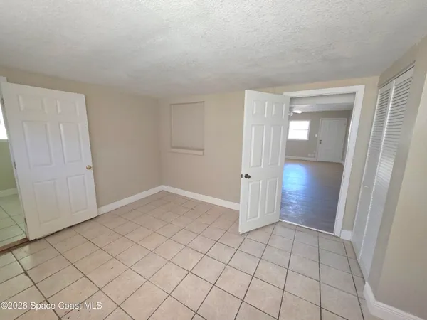 a view of an empty room and closet area