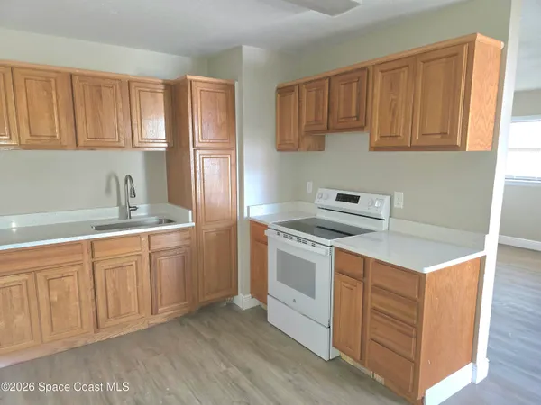 a kitchen with stainless steel appliances granite countertop a stove a sink dishwasher and a refrigerator