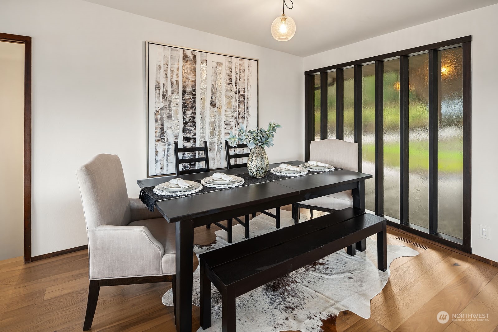 14050 184th Avenue Northeast Woodinville, WA 98072 - Photo 11 of 38 a view of a dining room with furniture window and wooden floor