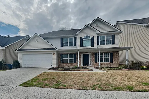 a front view of a house with garage