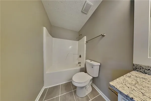 a bathroom with a toilet a sink and shower