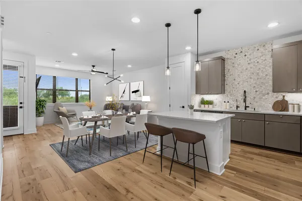 a large kitchen with a table and chairs