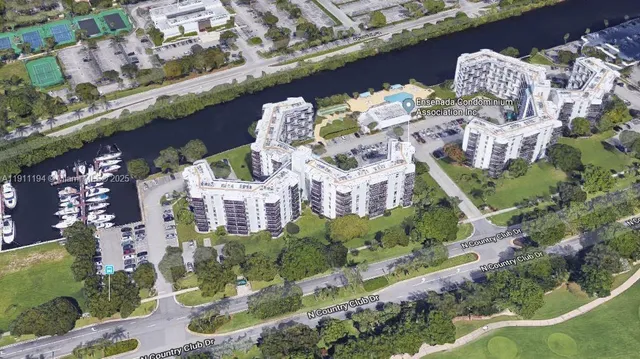 a aerial view of a house with a yard and large trees