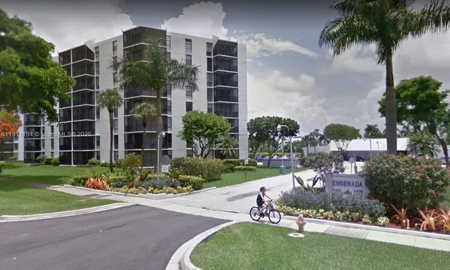 a view of a garden with a chair and potted plants