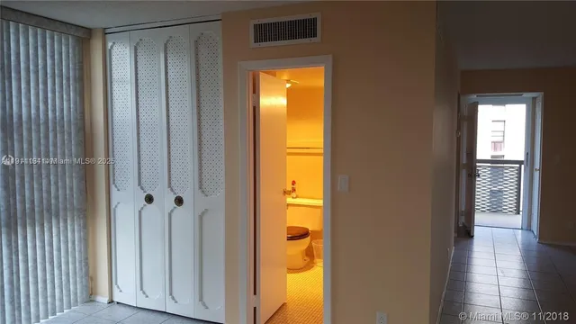 a kitchen with a refrigerator and a stove top oven