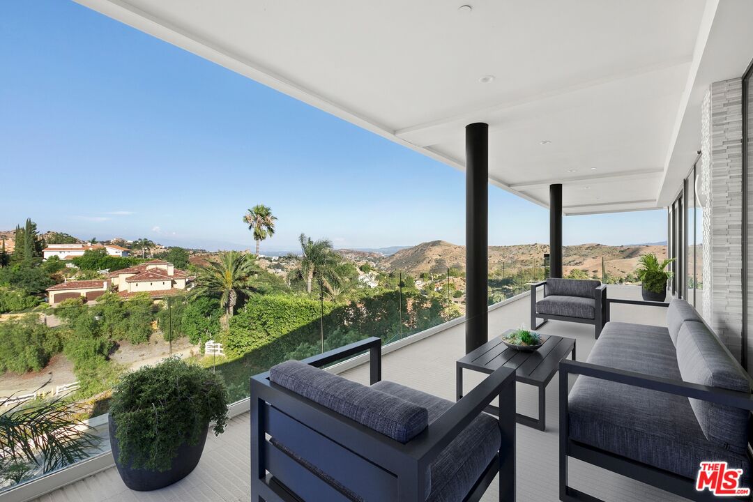 167 Saddlebow Road Bell Canyon, CA 91307 - Photo 13 of 33 a living room with patio furniture and a potted plants