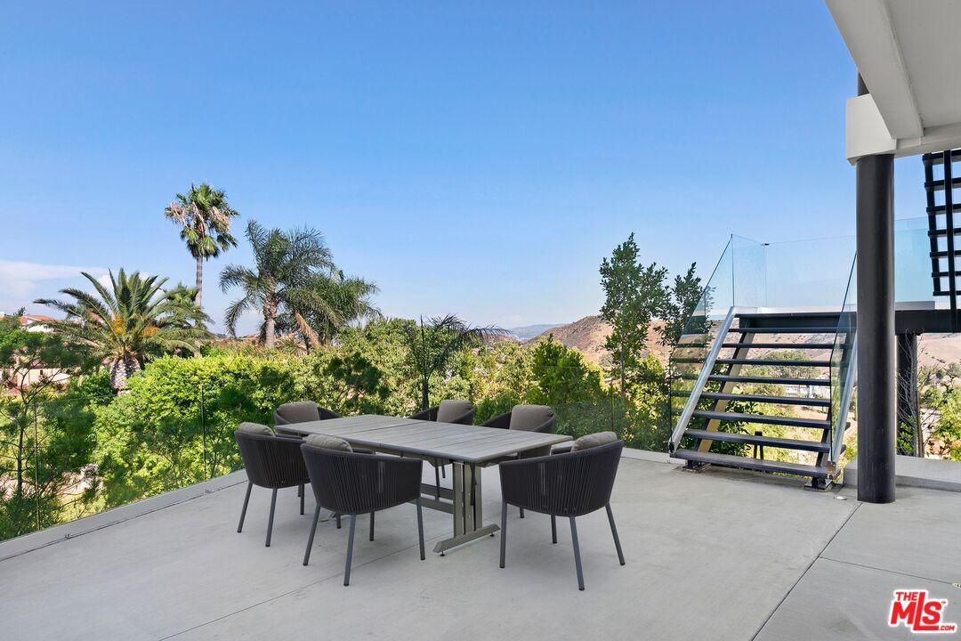 167 Saddlebow Road Bell Canyon, CA 91307 - Photo 20 of 33 a backyard of a house with table and chairs