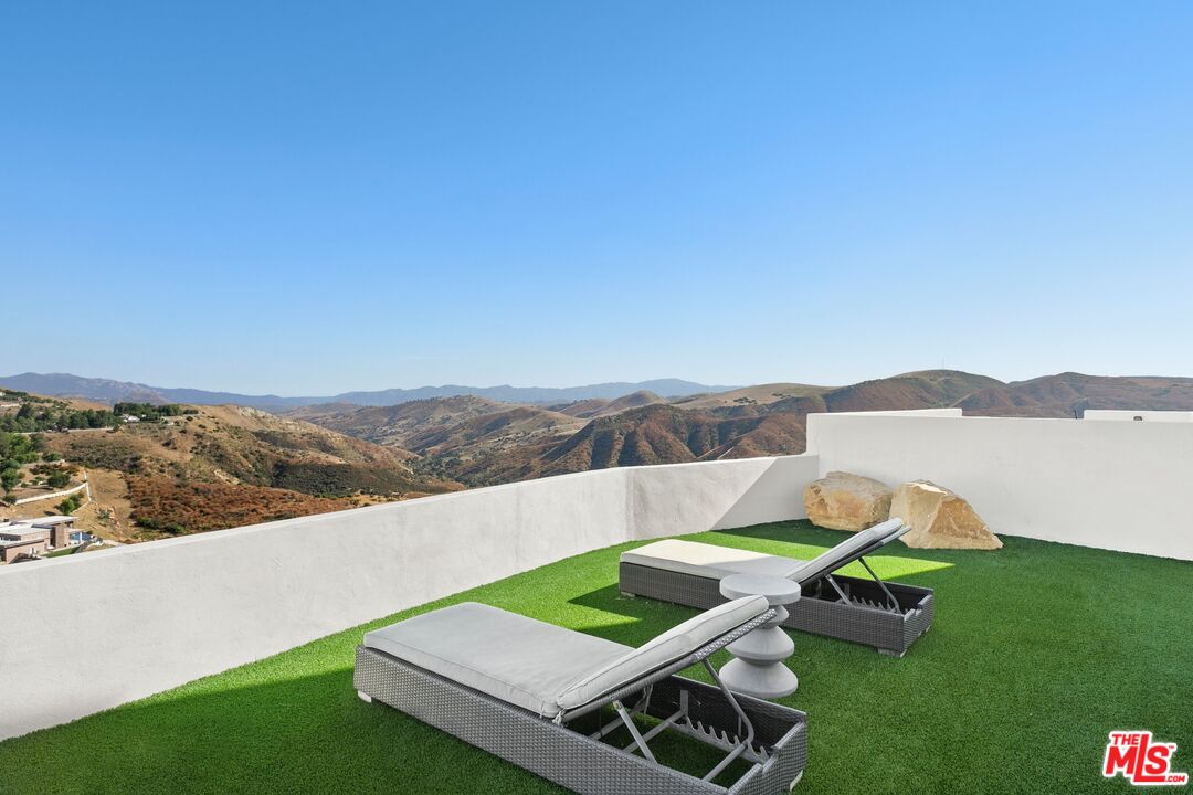 167 Saddlebow Road Bell Canyon, CA 91307 - Photo 23 of 33 a view of a two chairs in the garden near the lake