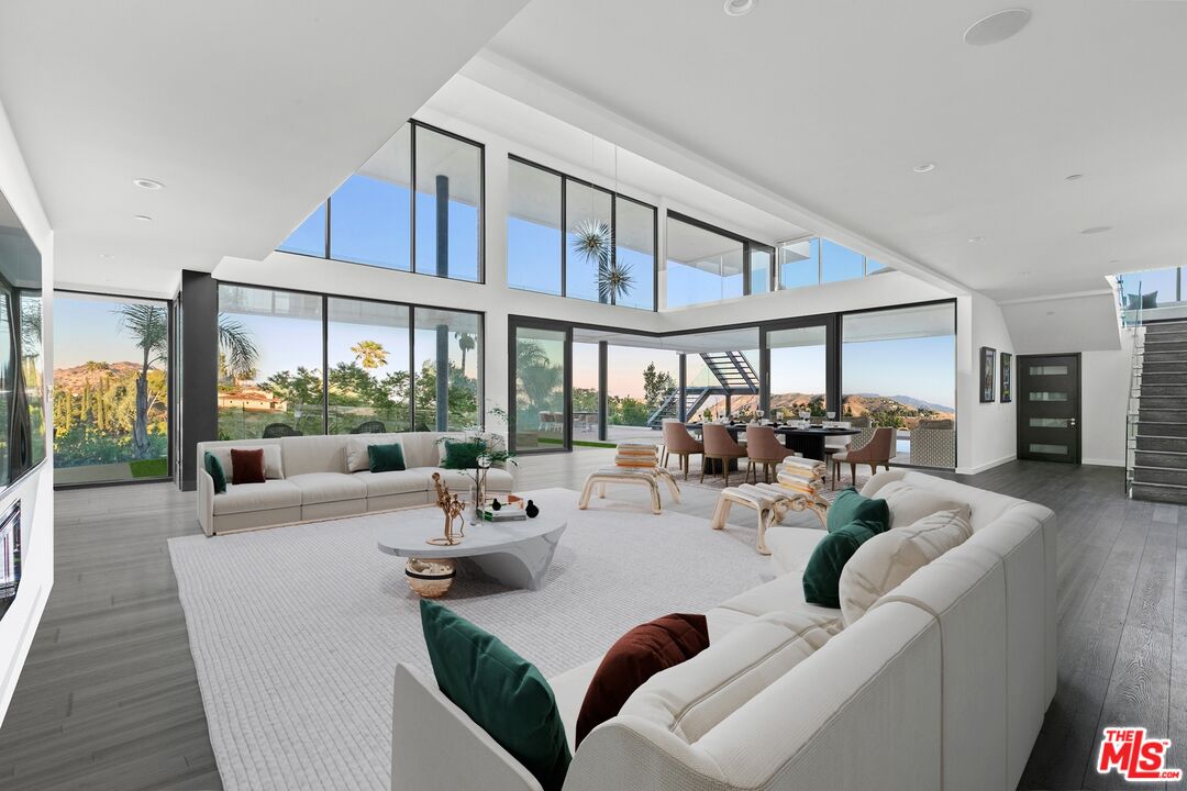 167 Saddlebow Road Bell Canyon, CA 91307 - Photo 3 of 33 a living room with furniture fireplace and a large window