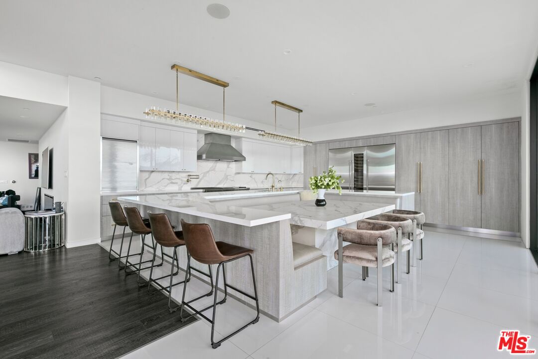 167 Saddlebow Road Bell Canyon, CA 91307 - Photo 6 of 33 a dining hall with stainless steel appliances kitchen island a table and chairs in it