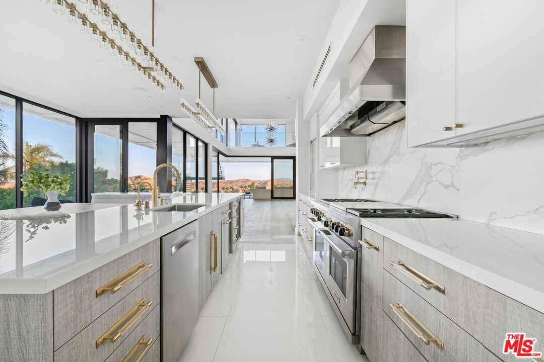 167 Saddlebow Road Bell Canyon, CA 91307 - Photo 7 of 33 a kitchen with stainless steel appliances granite countertop a sink a stove and a refrigerator