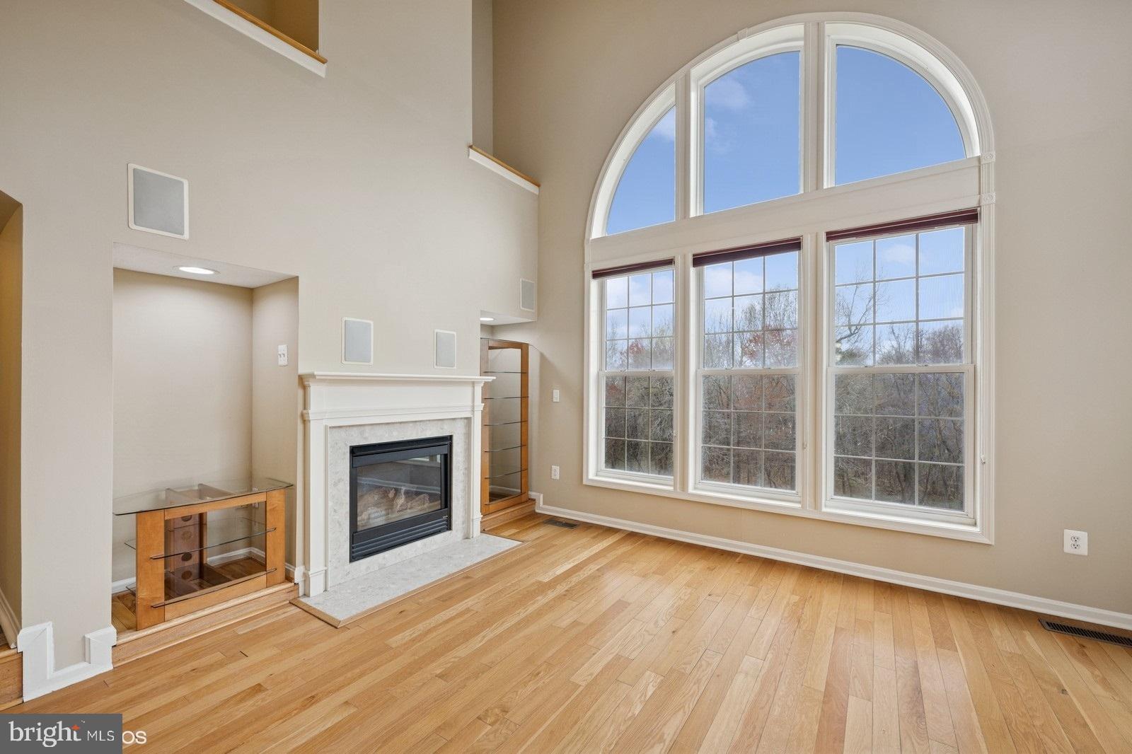 6965 Hawkins Gate Road La Plata, MD 20646 - Photo 13 of 55 a view of an empty room with wooden floor fireplace and a window