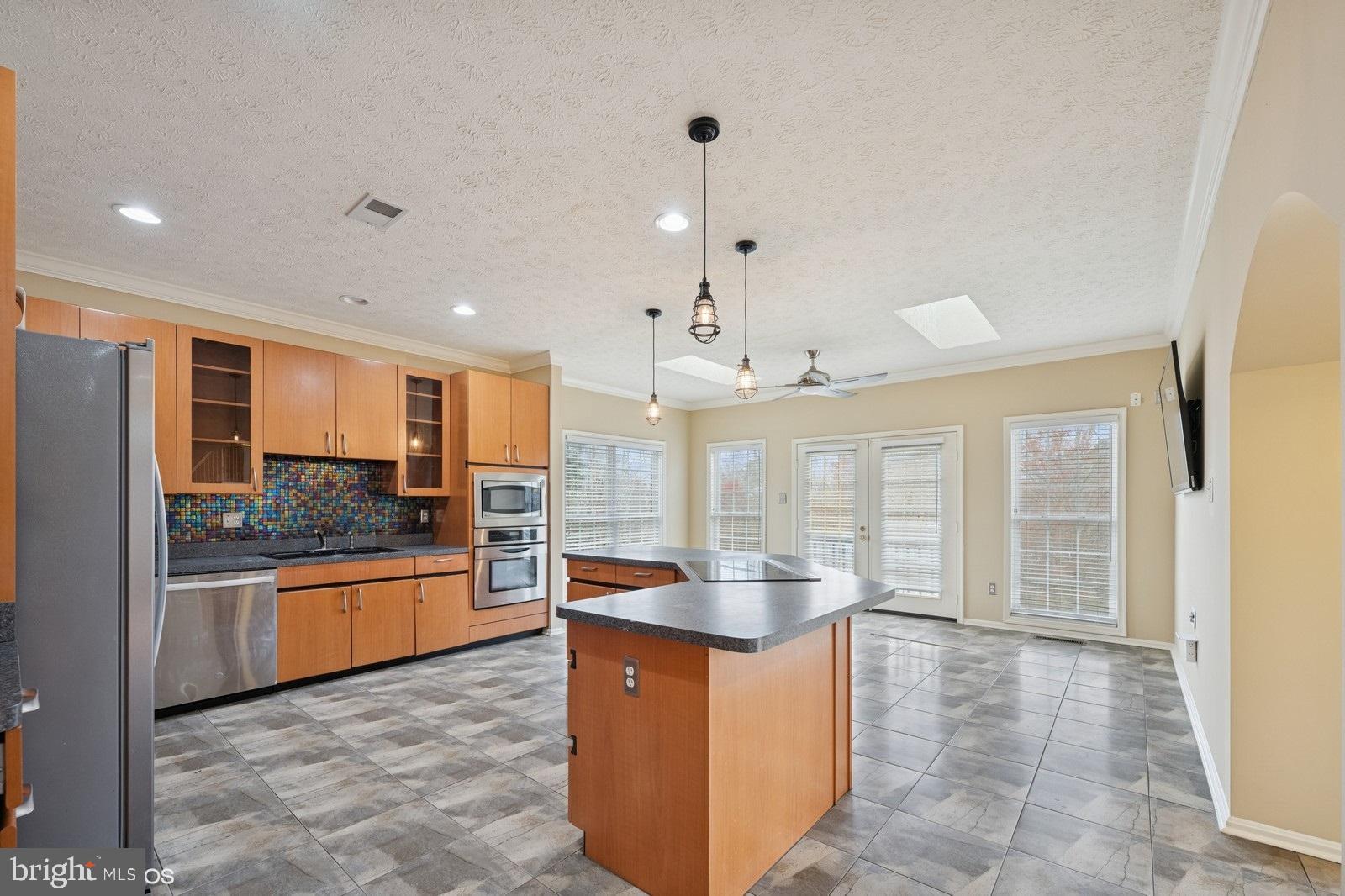 6965 Hawkins Gate Road La Plata, MD 20646 - Photo 17 of 55 a large kitchen with kitchen island granite countertop a large counter top and stainless steel appliances