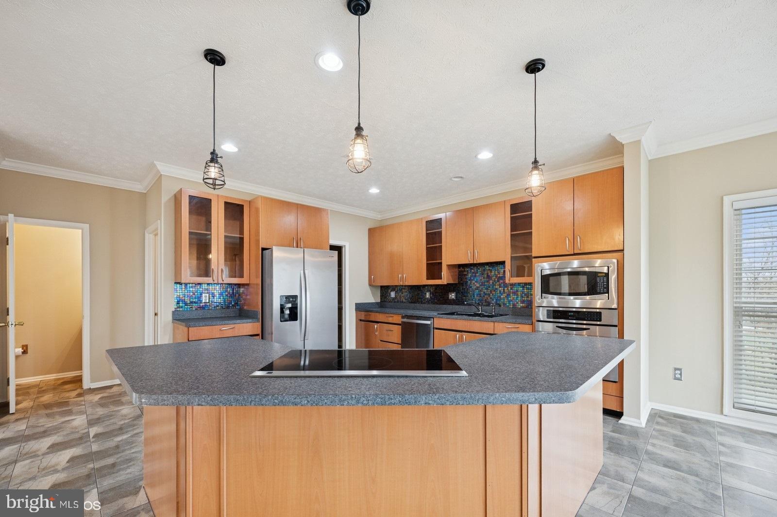 6965 Hawkins Gate Road La Plata, MD 20646 - Photo 18 of 55 a kitchen with stainless steel appliances granite countertop a sink a stove and a wooden floors