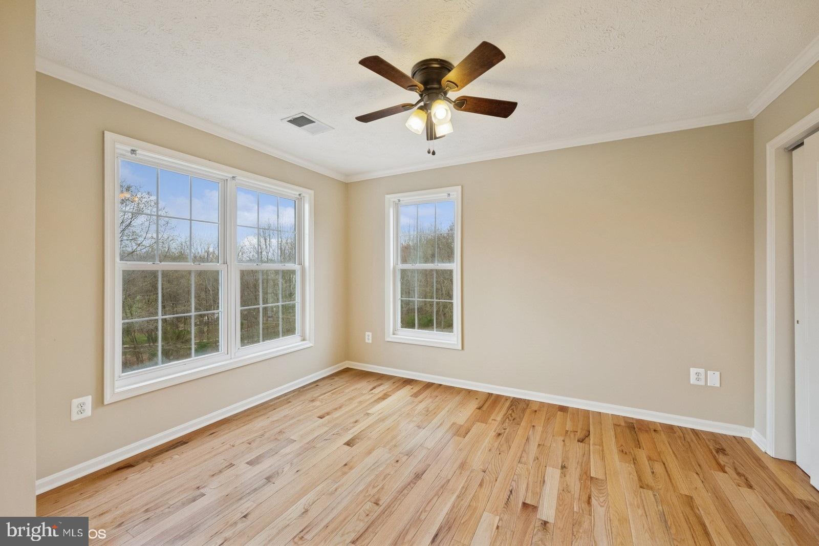 6965 Hawkins Gate Road La Plata, MD 20646 - Photo 28 of 55 an empty room with wooden floor and windows