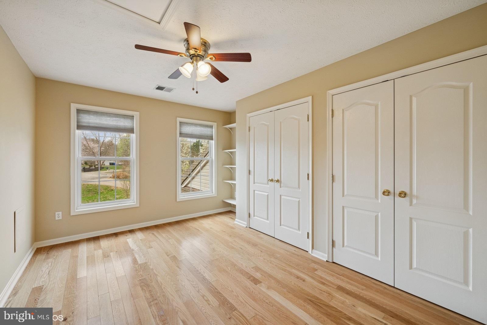 6965 Hawkins Gate Road La Plata, MD 20646 - Photo 30 of 55 an empty room with wooden floor chandelier fan and windows