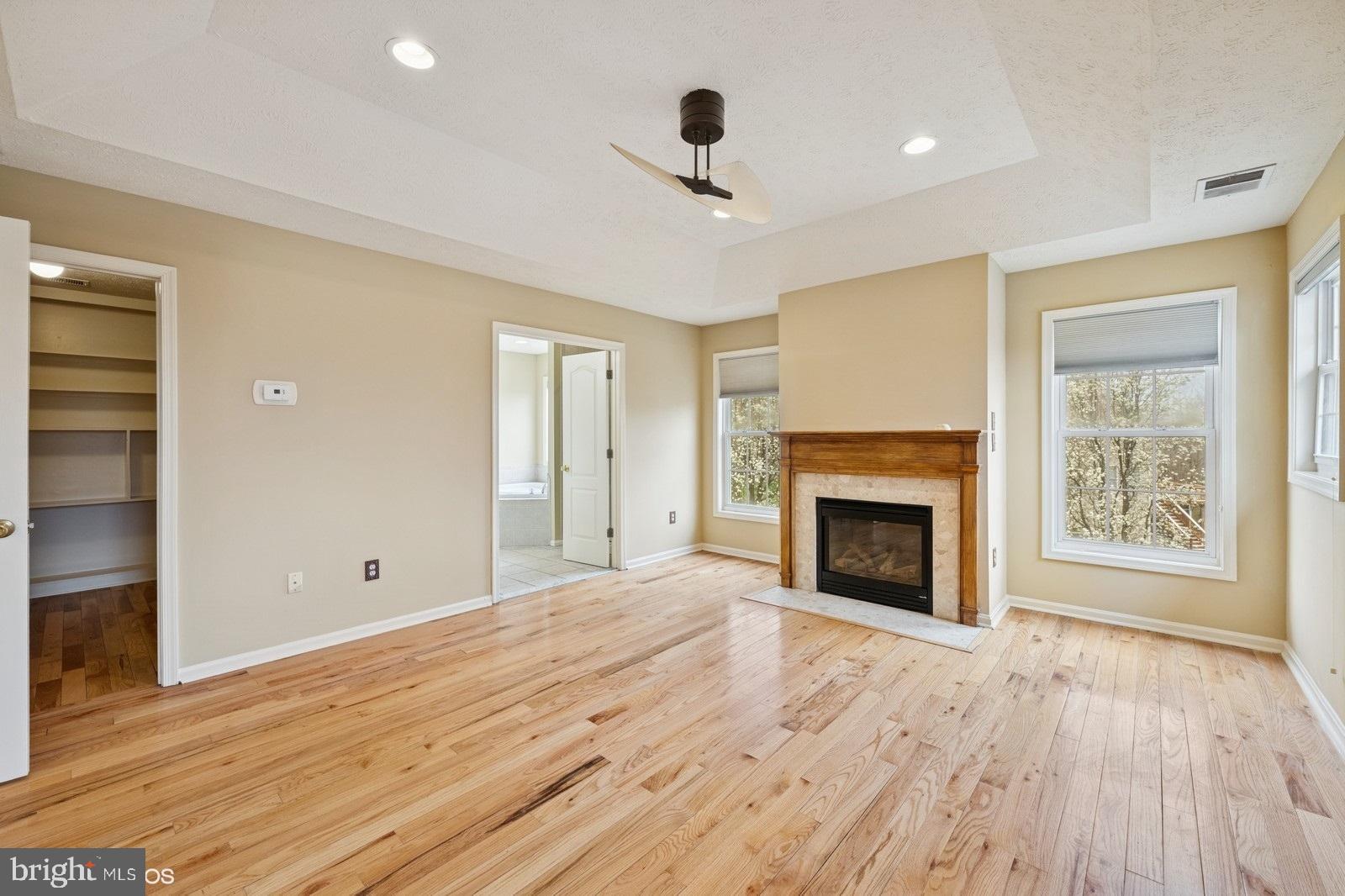 6965 Hawkins Gate Road La Plata, MD 20646 - Photo 34 of 55 a view of an empty room with wooden floor fireplace and a window