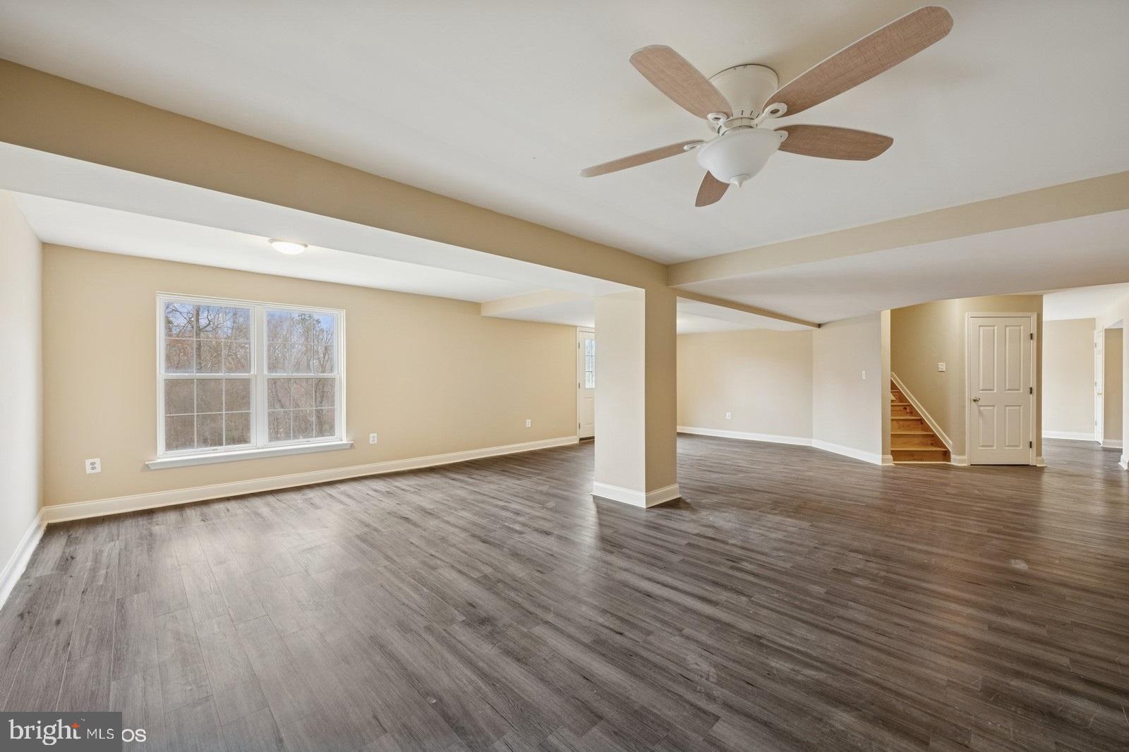 6965 Hawkins Gate Road La Plata, MD 20646 - Photo 42 of 55 a view of an empty room with wooden floor and a ceiling fan