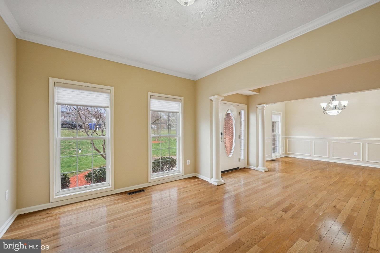 6965 Hawkins Gate Road La Plata, MD 20646 - Photo 5 of 55 a view of an empty room with wooden floor and a window