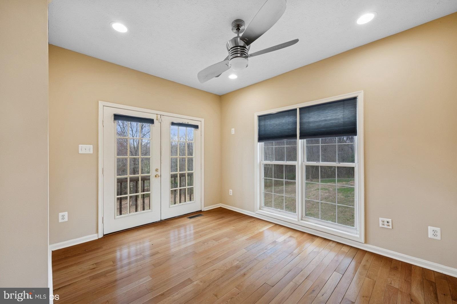 6965 Hawkins Gate Road La Plata, MD 20646 - Photo 10 of 55 an empty room with wooden floor and windows