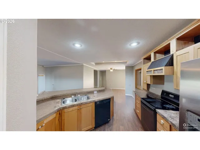 a open kitchen with stainless steel appliances granite countertop a sink a stove and a refrigerator