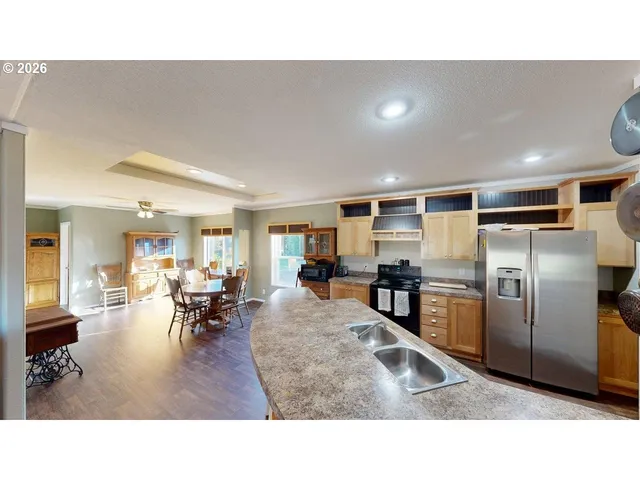 a kitchen with refrigerator and chairs