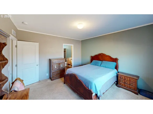 a bedroom with a bed and a lamp