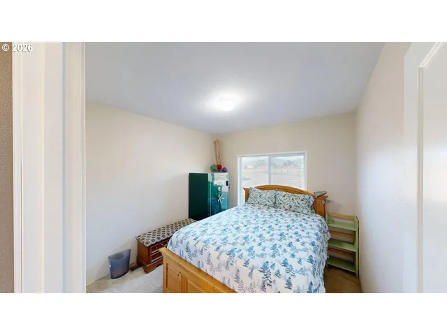 a bedroom with a bed and a dresser