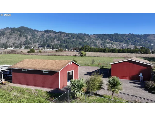 a view of a house with a yard and mountain