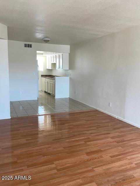 1809 N Spring, Unit 202 Mesa, AZ 85203 - Photo 3 of 4 a view of empty room with wooden floor and fan