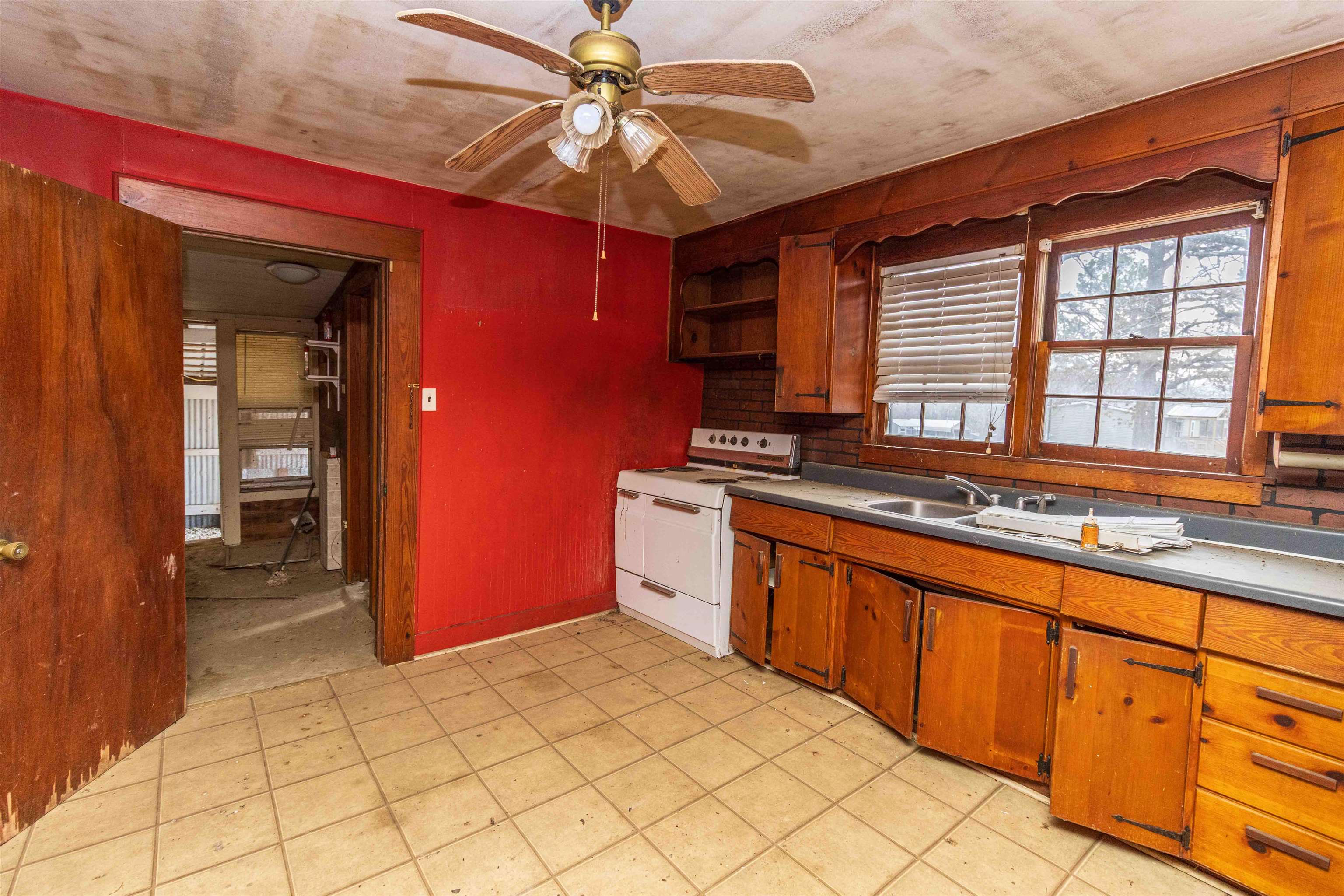 4850 Pleasant Site Road Selmer, TN 38375 - Photo 9 of 18 a kitchen with stainless steel appliances granite countertop a stove a sink and a microwave