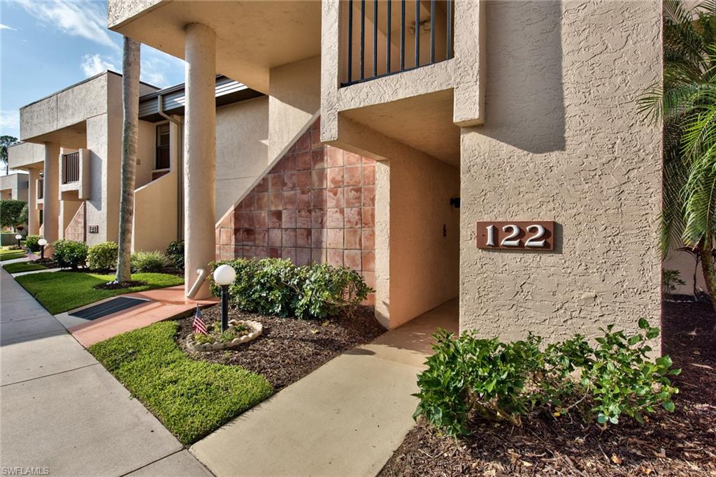 14730 Eagle Ridge Drive, Unit 122 Fort Myers, FL 33912 - Photo 1 of 27 a view of a brick house with a yard and plants