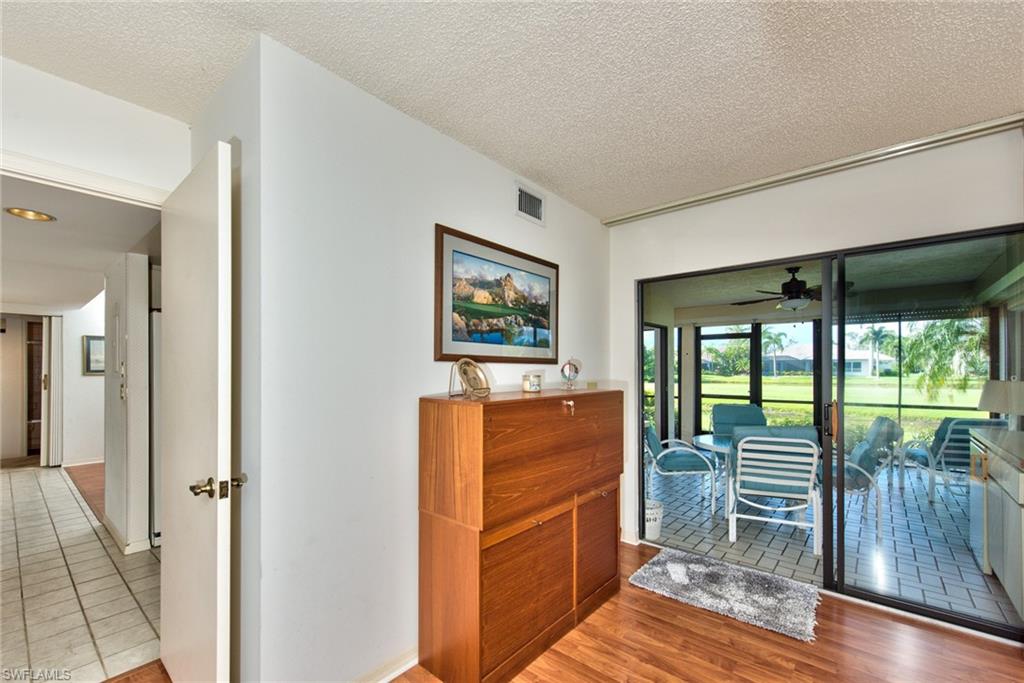 14730 Eagle Ridge Drive, Unit 122 Fort Myers, FL 33912 - Photo 11 of 27 workspace with wooden floor and windows