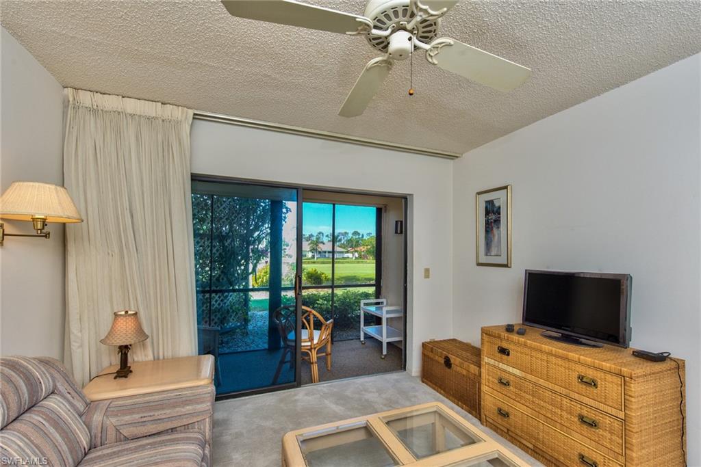 14730 Eagle Ridge Drive, Unit 122 Fort Myers, FL 33912 - Photo 15 of 27 a bedroom with furniture and a flat screen tv