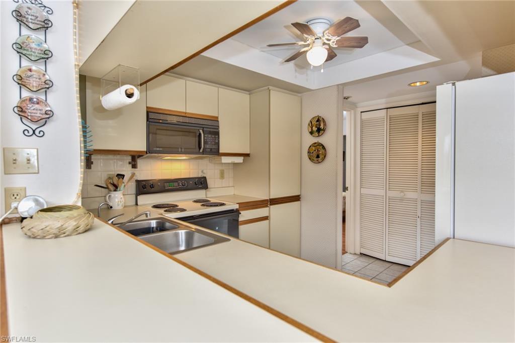 14730 Eagle Ridge Drive, Unit 122 Fort Myers, FL 33912 - Photo 19 of 27 a kitchen with stainless steel appliances a stove a refrigerator and a refrigerator