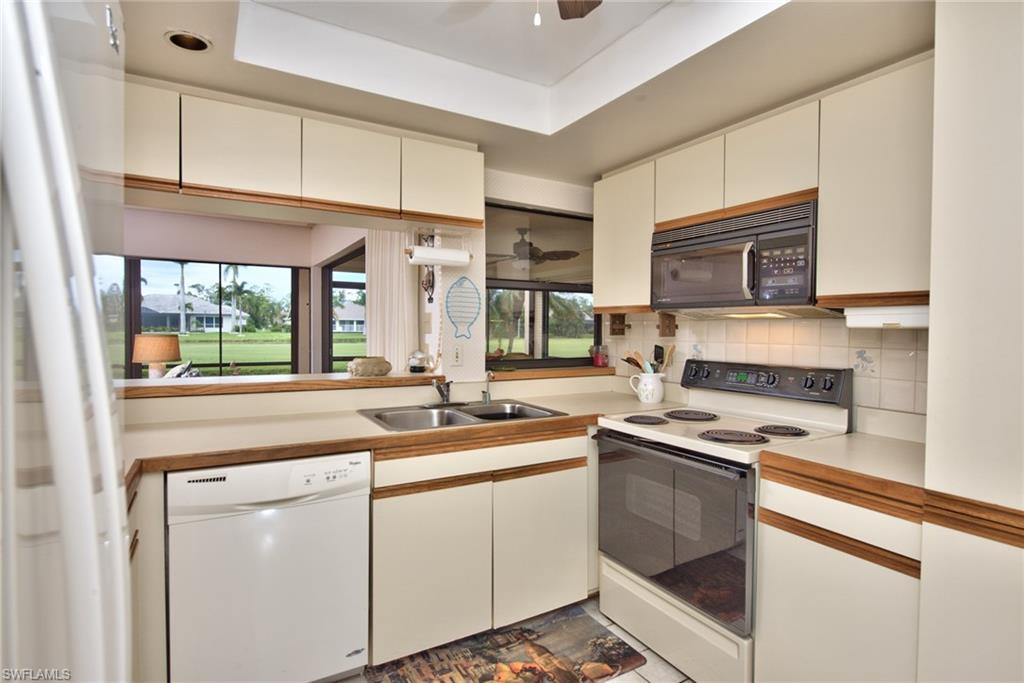14730 Eagle Ridge Drive, Unit 122 Fort Myers, FL 33912 - Photo 20 of 27 a kitchen with stainless steel appliances granite countertop a sink stove and cabinets