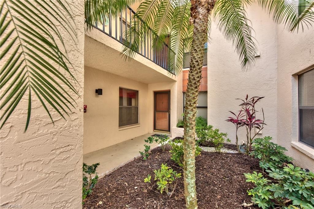 14730 Eagle Ridge Drive, Unit 122 Fort Myers, FL 33912 - Photo 23 of 27 a front view of a house with a yard