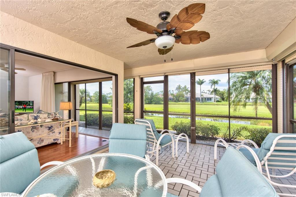 14730 Eagle Ridge Drive, Unit 122 Fort Myers, FL 33912 - Photo 5 of 27 a living room with furniture pool view and large windows