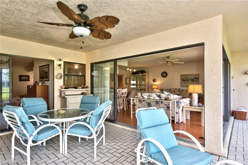 14730 Eagle Ridge Drive, Unit 122 Fort Myers, FL 33912 - Photo 8 of 27 a view of a dining room with furniture wooden floor and chandelier