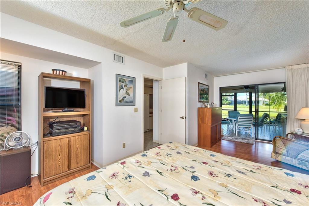 14730 Eagle Ridge Drive, Unit 122 Fort Myers, FL 33912 - Photo 10 of 27 a bedroom with a bed and a flat screen tv